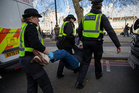 Metropolitan Police Officers remove a Palestine Action supporter after arrest during a demonstration. A small group of Palestine Action supporters were arrested outside New Scotland Yard after staging a protest in which they held signs backing the banned organisation. Around 18 demonstrators sat on the steps of the police headquarters displaying placards when Metropolitan Police officers moved in and began making arrests, following a recently reinstated policy to take action against public support for the group.