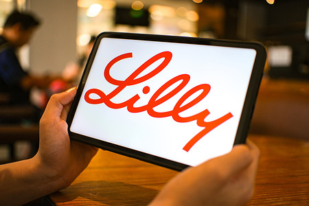 In this photo illustration, the Lilly logo is seen displayed on a tablet screen.