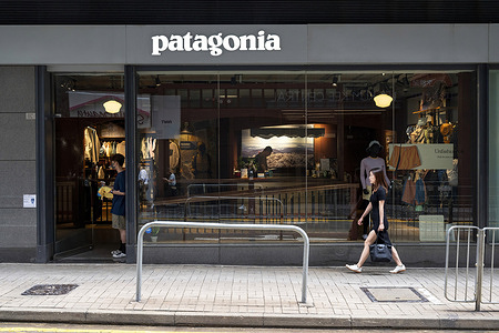 A pedestrian walks past the American outdoor clothing brand company Patagonia store.