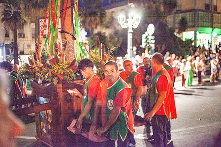 Participants in period costumes recreate the town's medieval and Aragonese history in the Sulcis region. Ferragosto celebrations feature the traditional Medieval historical parade marching through the streets of the historic center decorated with the famous colorful hanging umbrellas installations.