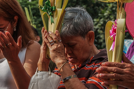 Catholic devotees attend Palm Sunday mass in Antipolo City. The rituals, which signifies the start of Holy Week, re-enacts the arrival of Jesus in Jerusalem. In Philippine culture, the blessed palms are kept as symbols of protection and victory.