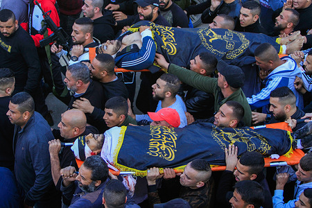 (EDITORS NOTE: Image depicts death)
Mourners carry the body of two Palestinians Naim Jamal Al-Zubaidi (27), and Muhammad Ayman Al-Saadi (26), who were killed by Israeli army bullets during clashes in the Jenin refugee camp in the West Bank. Israeli army forces stormed the Jenin camp to arrest wanted persons, wounding 35 Palestinians and killing two.