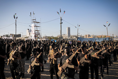 Young Palestinians hold wooden rifles as they demonstrate their skills during a military-style graduation ceremony at a summer camp organised by Islamic Jihad, in Gaza City.