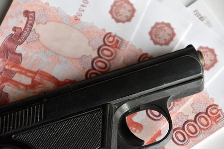 In this photo illustration, a gun is seen on top of the Russian 5000 ruble banknotes.
The Russian ruble plunged almost 30% against the dollar after the invasion of Ukraine. The United States and the European Union had declared that they would exclude certain Russian banks from the international system of Swift banking payments.