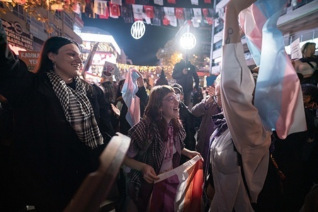 Protesters carry a trans flag during a demonstration. To mark the International Day for the Elimination of Violence against Women, Turkish women's organisations held a mass protest in Ankara.