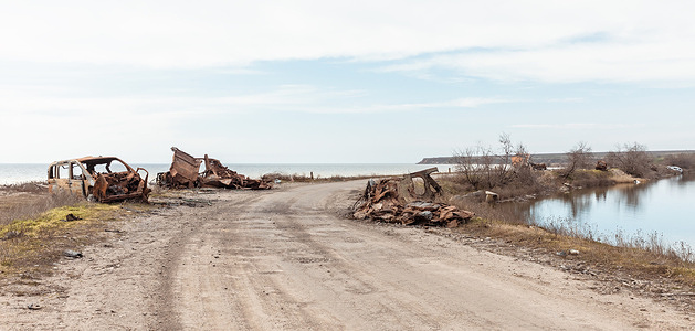Remains of burnt-out vehicles and other military equipment of Russian occupants seen on the bank of the Dnieper flood plain near Kherson.