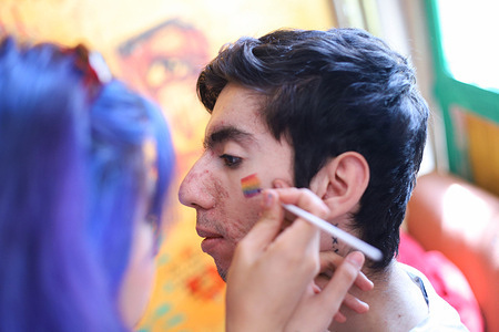 An activist gets a pride flag face painting before the Pride parade. Preparations for the Pride Parade continue in Istanbul. The police force closed most streets for the Pride parade, which the government banned. On the day of the march, as of 11:00 the subway coming to Taksim was closed.