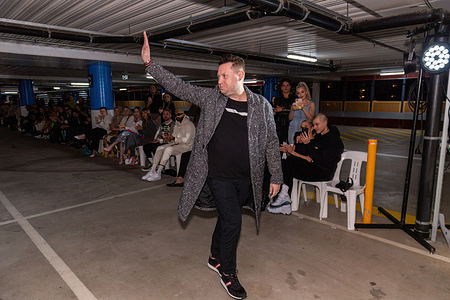 Designer Justin Cassin walks the runway at his Melbourne Fashion Week Runway Docklands, Melbourne. Justin Cassin men's wear designer staged his Melbourne Fashion Week runway event at a car park in the Docklands, Melbourne, Australia. The event attracted many young and beautiful fashion fans and influencers who watched the event.