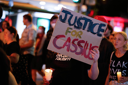 Protesters carry candles and a placard during a vigil. Protesters gathered in Brisbane for a candlelight vigil for Indigenous teenager Cassius Turvey, who was assaulted during a racist attack as he walked home from school in Perth, Western Australia last month. 15 year-old Turvey died from his wounds ten days later on the 23rd of October. Protesters in many towns and cities around the country simultaneously called for action on racially motivated violence and poor police practices.