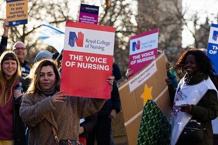 Nurses hold placards expressing their opinion during the demonstration outside St Thomas' Hospital in London. The Royal College of Nursing has called its members to strike in England, Wales and Northern Ireland over pay and working conditions where the government still refuses to offer a pay rise.