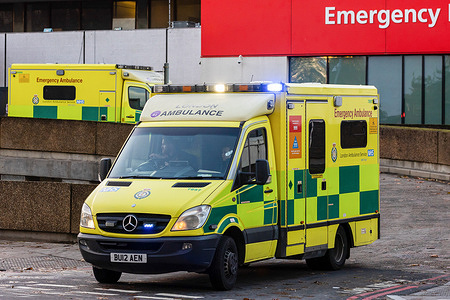 An ambulance on a blue light run belonging to the London Ambulance Service leaves St Thomas' Hospital. More than 10,000 NHS ambulance staff from nine NHS hospital trusts in England and Wales will walk out tomorrow in a dispute over pay.