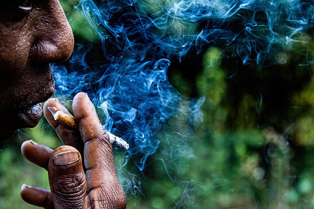 A man smokes a cigarette at Makao village near Nakuru Town. A study conducted by researchers at California's UC Davis Comprehensive Cancer Center says nearly half of the deaths from 12 cancer types are due to tobacco use.