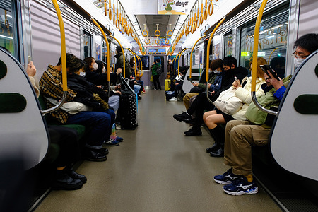 Commuters wearing face masks as a preventive measure against the spread of covid-19 use a train to the suburb of Tokyo. Japan on Friday reported 245,542 coronavirus cases, up 18,638 from Thursday. Tokyo reported 20,720 new cases, down 15 from Thursday. The number of infected people hospitalized with severe symptoms in Tokyo was 53, up four from Thursday, health officials said. The nationwide figure was 659, up nine from Thursday. The number of coronavirus-related deaths reported nationwide was 456.