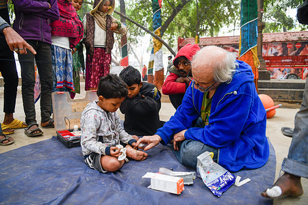 Brother Lucio Beninati, an Italian Catholic missionary from the Pontifical Institute for Foreign Missions (PIME), offers first aid to a street child at a park. Brother Lucio Beninati, an Italian Catholic missionary from the Milan-based Pontifical Institute for Foreign Missions (PIME), has worked in Bangladesh for the past 23 years. Brother Lucio tries to cultivate a sense of respect and togetherness with marginalized children and their families. The plight of poor people caught his attention and he decided not to start a family for himself, but to serve the big family — humanity.