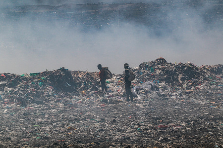 Waste pickers recover waste for recycling amidst heavy smoke from burning garbage at the Nakuru main dumping yard. Since waste is rarely segregated and is heavily mixed with all sorts of trash, burning it can produce potentially toxic fumes that can be a public health problem and can also contribute to climate change. Communities working and living near dumping sites where garbage is openly burned are at risk of contracting respiratory diseases and cancers. Women exposed to those fumes may suffer from reproductive health problems.