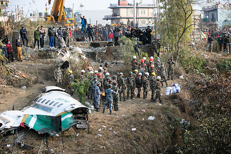 Nepal army, Police officers, and Armed Police Force (APF) Rescuers recover the body of a victim who died in a Yeti Airlines plane crash in Pokhara. Nepal observed a day of mourning on January 16 for the victims of the nation's deadliest aviation disaster in three decades, with 67 people confirmed killed in the plane crash.