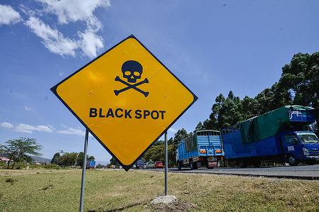 Vehicles drive past a road sign warning motorists of a black spot 5km west of Nakuru Town on the busy Nakuru-Nairobi Highway. In 2022, Kenya recorded an increase in the death toll from road accidents, reporting 4,432 in November compared to 4,271 during the same period in 2021, a 3% increase.