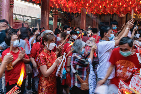 Thai-Chinese seen praying at Tai Hong Kong shrine. Lunar New Year begins on January 22, and welcomes the year of the Rabbit, celebrated by the Chinese around the world.