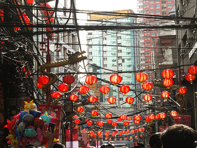 Traditional Chinese Red Lanterns hang on Ongpin Street. The Chinese-Filipino community, Filipinos and tourists enjoy the Lunar New Year's festivities in Binondo (Manila's Chinatown) in the Philippines after two years hiatus due to the Covid-19 pandemic.