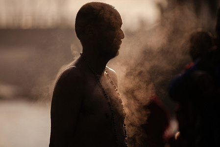 A Nepalese Hindu devotee offers prayers next to the Triveni river during the Swasthani Brata Katha festival in Panauti Village. Nepalese Hindu devotees participate in the month-long festival dedicated to God Madhavnarayan and Goddess Swasthani. The festival involves reciting folk tales about miraculous feats performed by them in many Hindu households.
