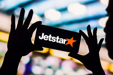 In this photo illustration, the Jetstar Airways logo is displayed on a smartphone screen.