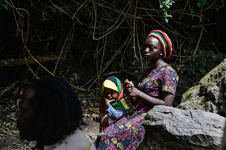 An adherent of the Rastafari sect accompanied by a young girl sing during the group’s special prayer and worship meeting at Menengai forest in Bahati near Nakuru Town. The Nakuru Rastafari community has decried government’s decision to introduce genetic modified crops in Kenya, saying the country is blessed with availability of fertile land. They are asking the government to sink more boreholes to increase irrigation instead of allowing GM seeds. A few months after President William Ruto took over government, he announced the reversal of a 10 year ban on the GM crop growing to address food security caused by consecutive years of failed rains. According to a survey by Root to Food Initiative, a non-governmental organization, 57% of Kenyans do not welcome GMOs over health concerns.