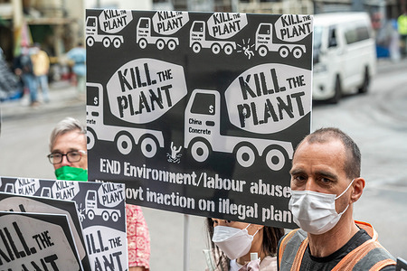 James Ockenden (R) leads a group of environmental and labour rights activists during the demonstration at the China Concrete Company's plant. A group of environmental and labour rights activists converged to protest against government inaction on closing the polluting cement plant with a history of violations and no current license to operate. This was one of the first approved protests since COVID-19 social distancing measures were eased in Hong Kong and could mark the return of the city's active social movements.