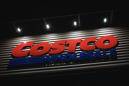 A logo of Costco. Costco is an American international retailer that specializes in bulk goods and groceries.