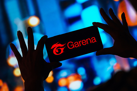 In this photo illustration, the Garena logo is displayed on a smartphone screen.