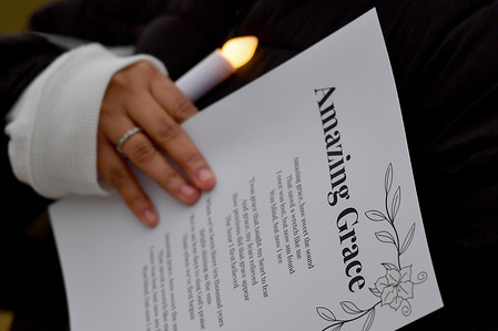 A student holds a candle and the Amazing Grace lyrics on a paper at a vigil for Tyre Nichols. Wilkes University held a vigil to bring attention to the death of Tyre Nichols. The vigil included speeches bringing awareness to the need for change in policing, the singing of Amazing Grace and a Three Minute moment of silence for Tyre Nichols.