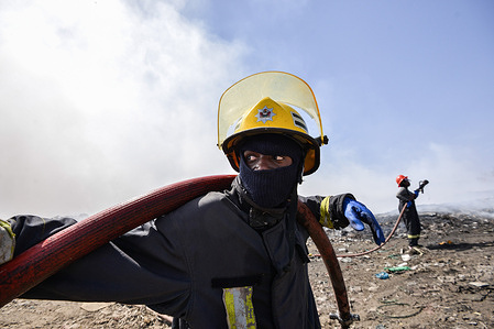 Firefighters attempt to extinguish a fire that has been burning for over three months at Gioto garbage dump. Efforts to quell it were made difficult by current dry weather and strong winds. Burning garbage in dumping sites and landfills is exacerbating climate change besides directly impacting health.