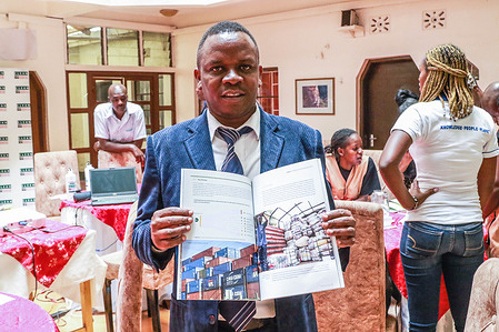 Betterman Simidi Musasia, founder and patron of Kenyan nonprofit Clean Up Kenya Organization poses for a photo while holding the report dubbed 'Trashion, the stealth export of waste plastic clothes to Kenya' that detailed how second hand clothes from European countries are turning out to be garbage. An investigation by Kenyan nonprofit environmental group Clean-Up Kenya and Wildlight for the Changing Markets Foundation found that European countries are dumping 37 million items of unusable plastic clothing in Kenya every year. The investigation found that more than one in three pieces of used clothing shipped to Kenya are of substandard quality and immediately the bails are opened, they become waste.
