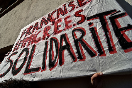 A protester holds a banner during the demonstration. Several hundreds of people demonstrated in Paris, Lyon and Marseille against the immigration bill and against the Administrative Detention Centers (CRA), demanding the regularization of undocumented migrants.