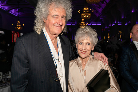Actress Lady Anita May Dobson (R) winner of an Icon award with her husband Sir Brian May (L) of the band Queen. This Is Icon - Awards, part of London Fashion Week, held a celebrity awards gala at the De Vere Grand Connaught Rooms London in Aid of charity Prost8 organized by Buzz Talent.