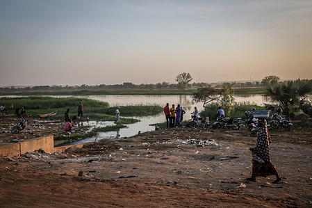 A girl walks along the banks of the Niger River in Niamey. Niger a landlocked West African country of roughly 25 million people - is one of the poorest countries in the world.