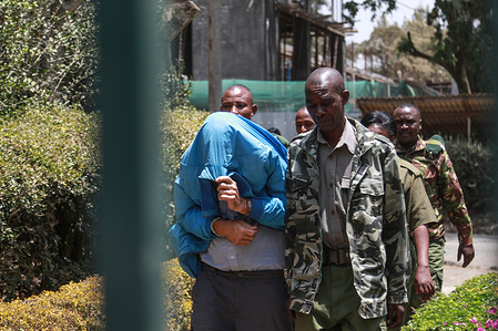 Martin Herman Baumgartner, 62, a German National is escorted by prison warders after appearing at Nakuru High Court for the hearing of his case where he is accused of sexually assaulting 10 minors on diverse dates in various parts of the country. The court ordered that Herman should be detained until 10 crucial witnesses testify.