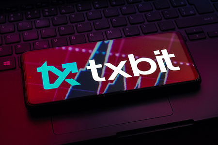 In this photo illustration, the Txbit logo seen displayed on a smartphone.