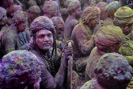 Hindu devotees are seen singing Cultural Holi Songs at the Radharani Temple of Nandgaon Mathura during the Holi festival. Holi Festival of India is one of the biggest colorful celebrations in India as many tourists and devotees gather to observe this colorful event. At the beginning of spring, the festival celebrates the divine love of Radha and Krishna and represents the victory of good over evil.