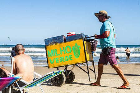 A beach vendor is seen at Acores Beach in Florianopolis. Beach vendors selling cold beverages and food are a common temporary occupation during the summer season in Brazil.