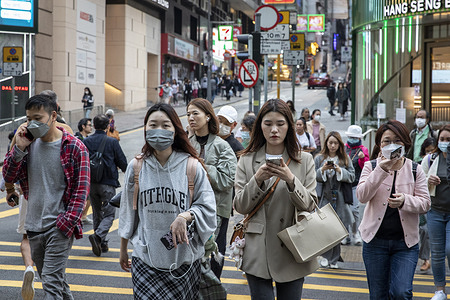 Pedestrians wearing masks and others without masks are seen crossing the crosswalk in Central, Hong Kong after the government ended the mandatory mask policy. The Hong Kong Government announced it would release mandatory mask requirements and all social distance policies on March 1, 2023, marking the end of the mask mandate in Hong Kong after 959 days.