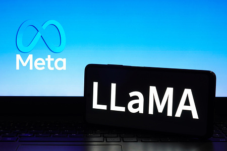 In this photo illustration, the LLaMA (Large Language Model Meta AI) logo seen displayed on a smartphone and the Meta Platforms logo in the background.