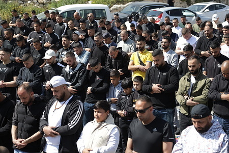 Muslim worshippers attend Friday prayers close to a protest area set up by activists against the demolition of houses by Israeli authorities in the mostly-Arab neighbourhood of Silwan in Israeli-annexed east Jerusalem.