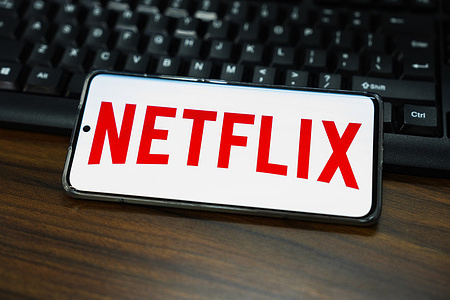 In this photo illustration, a Netflix logo is displayed on the screen of a smartphone.