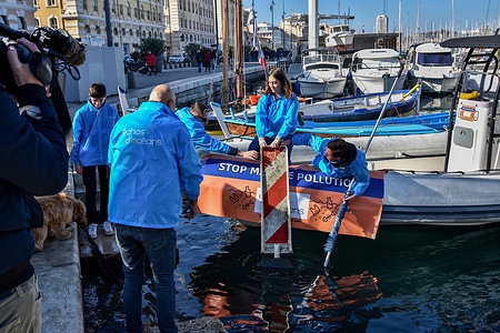 Volunteers from the Échos d'Océans association seen recovering a sign during the depollution of the waters of the Old Port of Marseille. The Échos d'Océans association cleans up the waters of the Old Port of Marseille using robots for an entire weekend.