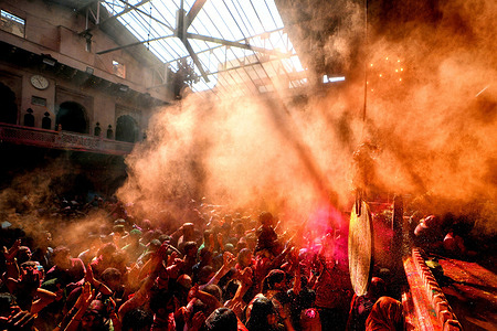 Hindu devotees are seen throwing colourful powders (Gulal) inside Radhaballav Temple of Vrindavan, as per the Traditional culture of ongoing Holi Festival. Radha Ballav Temple is one of the oldest and most auspicious temples for Hindus, where Lord Krishna is worshipped during Holi Festival.