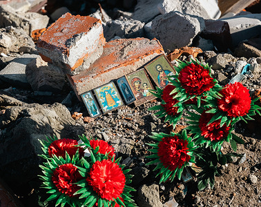 Icons and artificial flowers in memory of the city's dead. Memorial sites of local citizens killed by missile and artillery shelling by the Russian fascist army in Izyum, Kharkiv reg. Six months after the retreat of the Russian army, life in Izyum is gradually getting better, with electricity and water available, but the townspeople still suffer from the cold because broken boilers do not work. The city is no longer under fire, but the risk of an explosion is still high: mines, tripwires, or unexploded shells are still everywhere. Izyum was liberated on 10 September 2022 during an Armed forces of Ukraine counter-offensive in the Kharkiv region. The city has been badly damaged by Russian shelling and occupation - 80% of the buildings there have been damaged. The biggest problem is the shortage of communal equipment, which has either been stolen or destroyed. Mass graves of Ukrainian civilians and Ukrainian servicemen have been found in the vicinity of Izyum, including signs of torture.