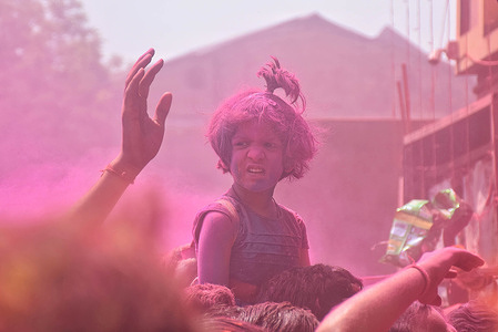 A kid with colorful powders seen during the Holi festival. Holi is a popular Hindu festival filled with so much fun and is celebrated to mark the beginning of spring season.