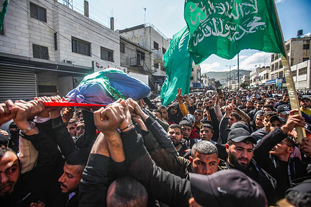 (EDITORS NOTE: Image depicts death)Mourners carry the body of Abdul Fattah Kharushah draped in the Hamas flag during his funeral in the West Bank city of Nablus. The Israeli army raided the occupied West Bank refugee camp of Jenin, leading to a gun battle that killed at least six Palestinians. The Israeli military said Kharushah, who was a member of the Hamas militant group, was the suspected assailant in the fatal shooting of two Israeli brothers in the northern West Bank town of Hawara last week.