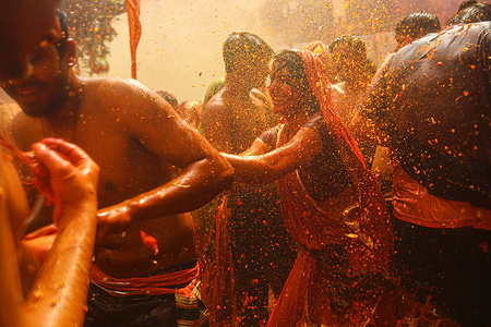 A woman dances during the 'Huranga', a game played between men and women a day after Holi, at Dauji temple near the northern city of Mathura in Uttar Pradesh.