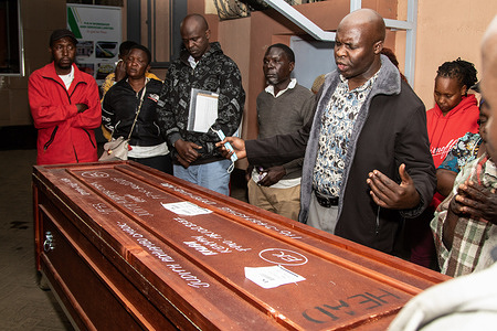 Mourners pray beside the casket containing the body of Judith Adhiambo at a morgue when it arrived from Saudi Arabia. Judith, a domestic worker, is reported to have died under unclear circumstances. Despite claims that Judith Adhiambo tripped in the bathroom, her family remains skeptical about the circumstances of her death due to reports of mistreatment of female domestic workers from Africa in Saudi Arabia. The family noted that despite assurances that her body was well-preserved, they found it in a terrible state and already decomposing. According to Kenya's Foreign Ministry, 89 Kenyans died in Saudi Arabia between 2020 and 2021, with most of the deaths attributed to cardiac arrest.